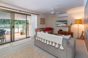 a living room with a couch and a balcony at Van Gogh - Location Location Location in Blueys Beach +12 photos