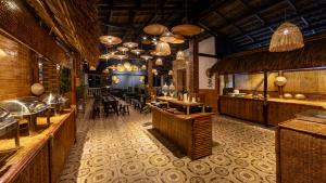 a restaurant with tables and chairs in a room at Le Gia Hotel in Da Lat