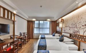 Zhangjiajie Huan Sha Ju Hotel的电视和/或娱乐中心