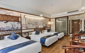 Zhangjiajie Huan Sha Ju Hotel客房内的一张或多张床位