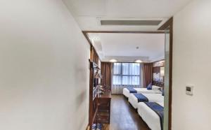 Zhangjiajie Huan Sha Ju Hotel客房内的一张或多张床位