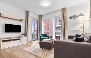 a living room with a couch and a tv at Schleieck in Kappeln