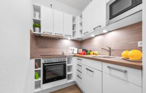 a kitchen with white cabinets and a sink at Schleieck in Kappeln
