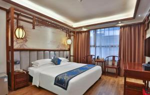 Zhangjiajie Huan Sha Ju Hotel客房内的一张或多张床位