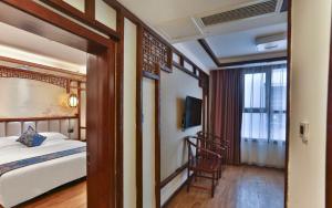Zhangjiajie Huan Sha Ju Hotel客房内的一张或多张床位
