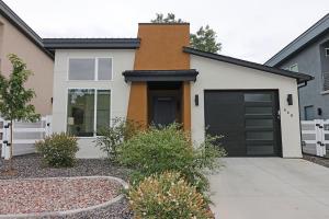 a white house with a black garage at Tranquil Modern Haven home in Grand Junction