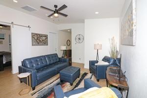 a living room with a blue couch and chairs at Tranquil Modern Haven home in Grand Junction