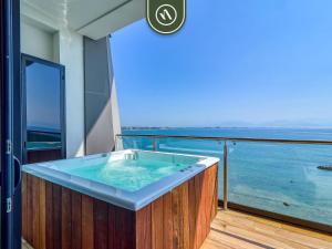 a hot tub on a balcony with a view of the ocean at Luxury Oceanfront 3 BR Condo - Private Jacuzzi in Cruz de Huanacaxtle
