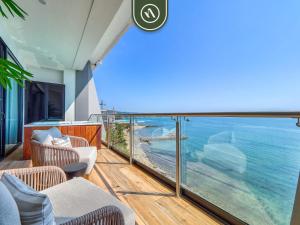 a balcony with chairs and a view of the ocean at Luxury Oceanfront 3 BR Condo - Private Jacuzzi in Cruz de Huanacaxtle +55 photos