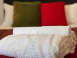 a white towel sitting on top of a bed at Hot Deal! Sky Stars Central Haven Studio with nice pool In CBD heart in Auckland +11 photos