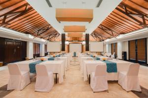 a large banquet hall with white tables and chairs at Ramayana Candidasa Beach Resort in Candidasa +100 photos