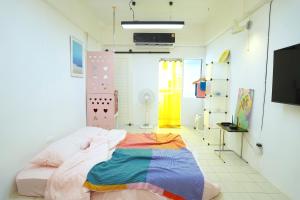 a bedroom with a bed with a colorful blanket on it at ModernArt, walk10min MRT, 30airport in Bangkok +50 photos