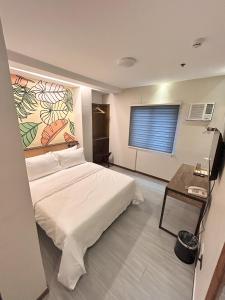 Postel nebo postele na pokoji v ubytování Maharlika City Inn