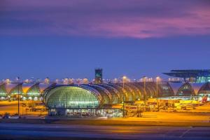 a large airport with a large building at night at GO INN Suvarnabhumi Airport Bangkok in Lat Krabang +6 photos