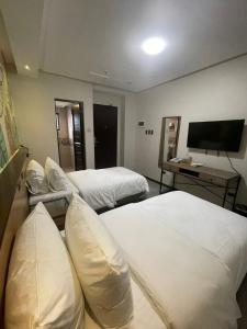 Postel nebo postele na pokoji v ubytování Maharlika City Inn