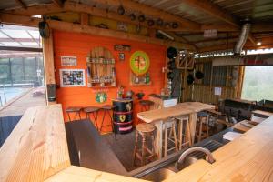 a kitchen with wooden tables and a stove in a room at Les Paillotes de la Haute Mazère in Pocé-sur-Cisse