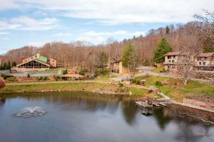 arial view of a lake with a house and a building at Bluegreen Vacations Blue Ridge Village, an Ascend Collection Resort in Banner Elk
