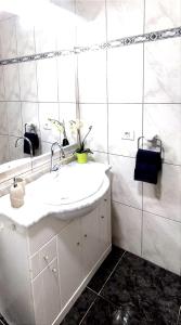 a white bathroom with a sink and a mirror at Buena pesca 7 in Puerto del Carmen