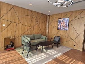 a living room with a couch and a table at Hilton Garden Inn Termez Airitom in Termiz +49 photos