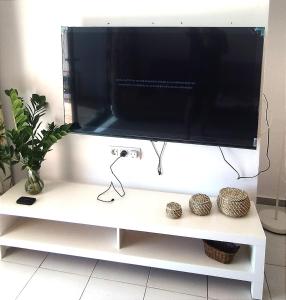 a flat screen tv sitting on a white tv stand at Buena pesca 7 in Puerto del Carmen
