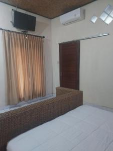 Postel nebo postele na pokoji v ubytování Rusma House Ubud