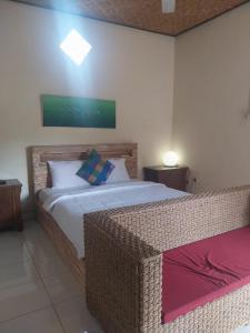 Postel nebo postele na pokoji v ubytování Rusma House Ubud