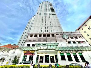 a tall white building with a clock on it at Mansion One Luxurious Seaview Vacation Homes in George Town