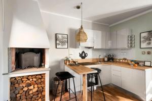 a kitchen with a wooden counter and a fireplace at SopraBosco Calcata Art & Design Apartment in Calcata