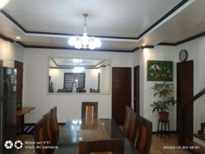 a dining room with a glass table and chairs at casa lilia in Tagaytay