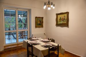 a dining room with a table with chairs and a window at Green Terrace 10min from TERMAL BATH in Komárom