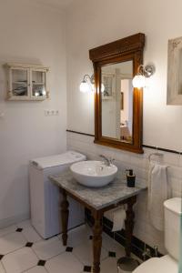 a bathroom with a sink and a toilet and a mirror at Green Terrace 10min from TERMAL BATH in Komárom