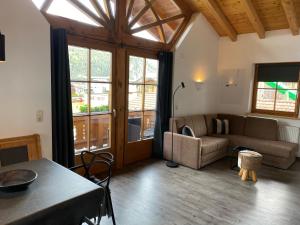 a living room with a couch and a table at Haus Albertha in Ehrwald