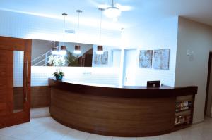 a lobby with a reception desk in a building at Hotel São José in São Fidélis