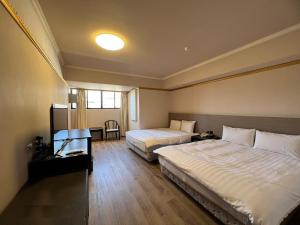 a hotel room with two beds and a window at Hotel Avenue in Hsinchu City