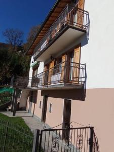 a building with balconies on the side of it at Casa del Sole in Casasco Intelvi