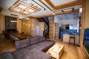 a living room with a couch and a table at Veni Vidi Villas Gabala in Gabala