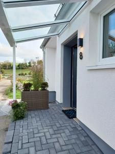 a patio with awning on the side of a house at Ferienhaus Birkelbach in Erndtebrück