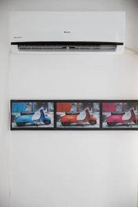 a white shelf with pictures of cars on it at Atheneum Star Residence in Bucharest