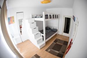a room with white bunk beds and a mirror at Atheneum Star Residence in Bucharest