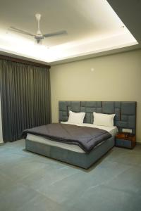 a bedroom with a large bed in a room at OVEL Hotel & RESORT in Ludhiana