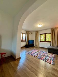 a living room with a couch and a rug at Charming two- bedroom house in Bucharest
