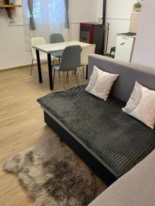 a couch with a rug in a room with a table at Cabana la Munte in Topliţa