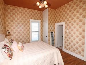 a bedroom with a bed and a window at Vintage Parlor home in Grand Junction