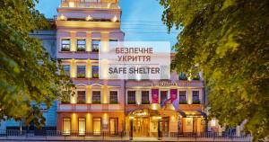 a building with a sign that reads berlin safe shelter at Swiss Hotel in Lviv