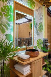 a bathroom vanity with a mirror and a sink at Bamboo Village Beach Resort & Spa in Mui Ne
