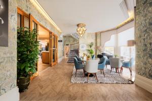 a dining room with a table and chairs at voco The Clifton Folkestone by IHG in Folkestone