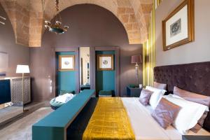 a bedroom with a large bed in a room at Maison Boutique At Viviana in San Pietro in Lama