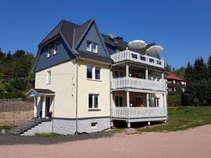 a large white house with a black roof at ferienwohnungen.ruhla in Ruhla