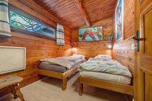 a room with two beds in a log cabin at Haus-am-Harz Bad Gandersheim in Bad Gandersheim