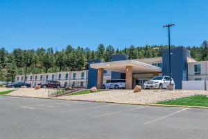 a large building with cars parked in a parking lot at Elevate Hotel at Sierra Blanca Ruidoso, an Ascend Collection Hotel in Ruidoso